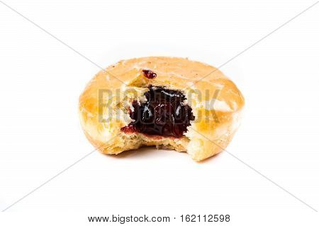 A Frosted Jelly Filled Donut With A Bite Out Of It Isolated On A White Background