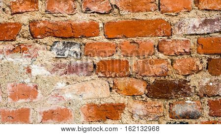 ancient red clay brick wall with cement and lime