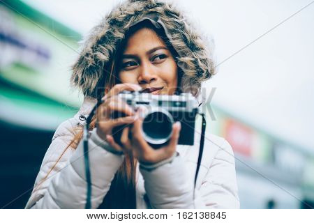 Freelancer asian photographer in a winter coat