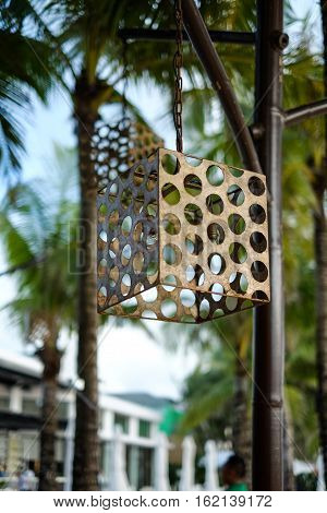 Lampshade on the beach among the palms