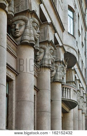 Architectural columns, windows with balcony in St. Petersburg and decorated with Egyptian sculptures