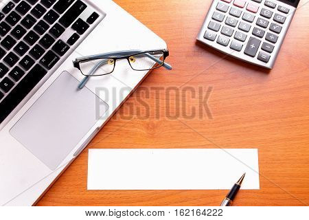 Office workplace with laptop and smart phone on wood table
