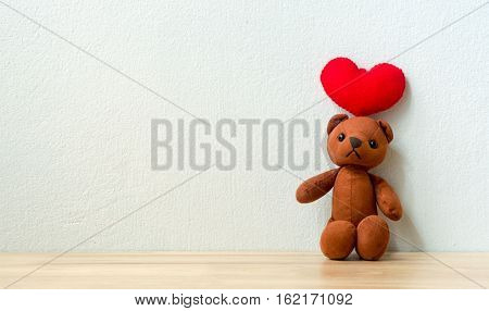 Bear with Heart on wood table love and valentine concept