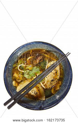 Gedza soup in a ceramic pot on a white background