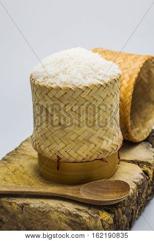 Jasmine rice in the kratip rice and on wood block.