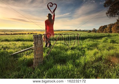 Escape To The Country - Female On Fence With Love Heart In Morning Light