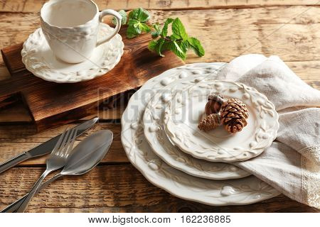 Set of dinnerware on wooden table