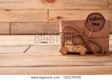 Pyrography car for Father's Day. Gift box with rope bow. How to congratulate dad.