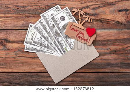 Cash and greeting card. Palm trees and fabric heart. Surprise for dad.