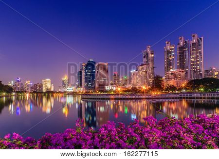 Cityscape image of Benchakitti Park at twilight time in Bangkok Thailand.