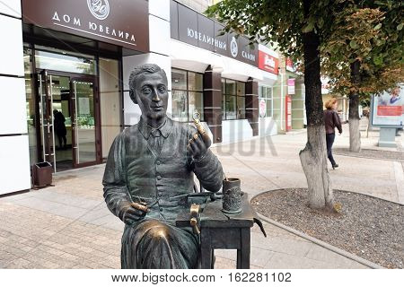 PENZA RUSSIA - AUGUST 28 2016: Sculpture on a background of a jewelry store in Penza. Jeweler holding a wedding ring