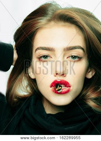 sexy young fashionable girl or woman with beautiful red lips pretty cute face stylish hair and humblebee bee in mouth in erotic black scarf closeup