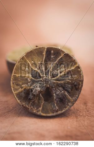 Molded lemon on a wooden background.Molded lemon Macro