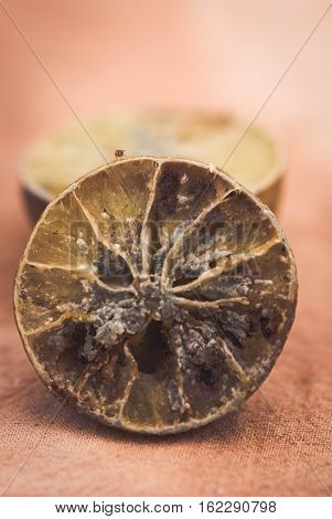 Molded lemon on a wooden background.Molded lemon Macro