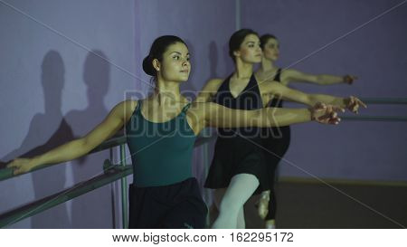 Ballerinas Practicing At Ballet Barre In the classroom
