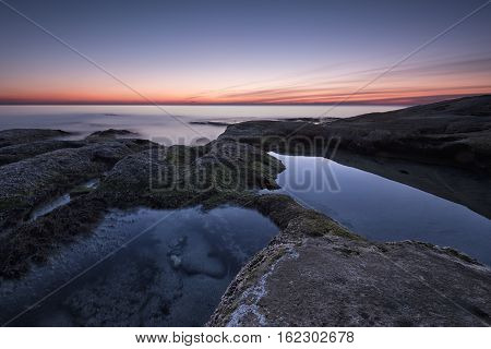 Seascape During Sunrise. Beautiful Natural Seascape, Blue Hour. Rocky Sunrise. Sea Sunrise At The Bl