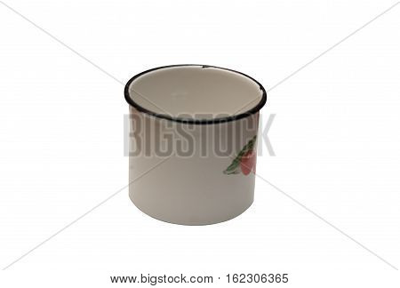 Old enamel metal mug on a white background. Ornamental cherry. December 1970.