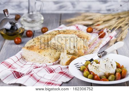 Italian focaccia bread with olives and basil