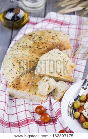 Italian focaccia bread with olives and basil