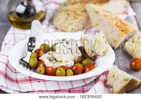 Italian focaccia bread with olives and basil