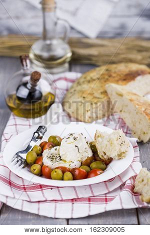 Italian focaccia bread with olives and basil