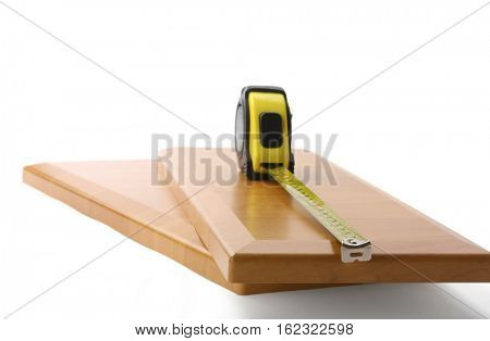 Wooden board and tools on a white background