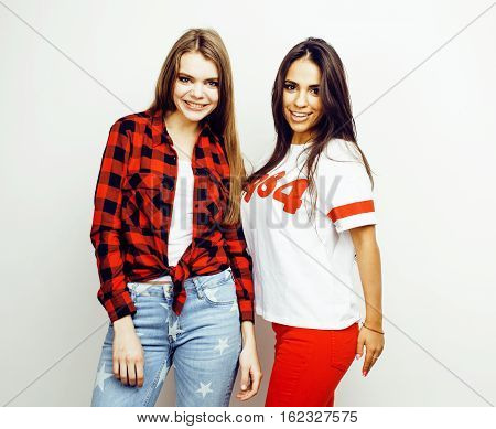 best friends teenage girls together having fun, posing emotional on white background, besties happy smiling, lifestyle people concept, blond and brunette multi nations close up