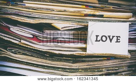 A Stack Of Old Newspapers, Words On A Paper Sticker