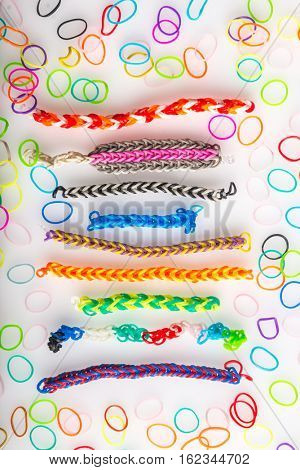 Set of assorted colorful wristbands made by loom bands. Children's favorite hobby.