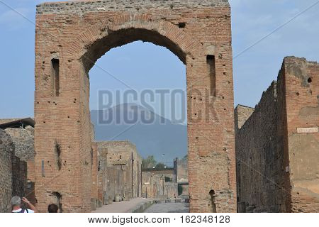 Mt Vesuvius seen through marketplace arch in Pompeii