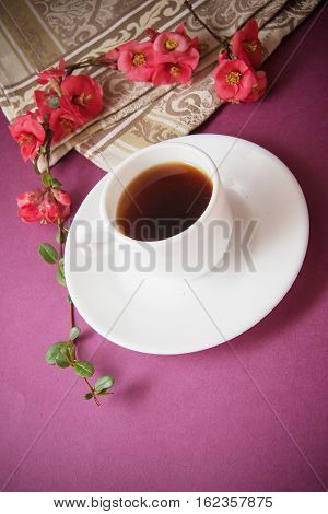 coffee cup with garnet flowers on branch