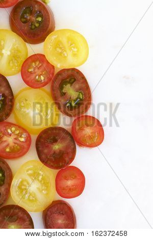 Tomato medley of different colours set out in halves.