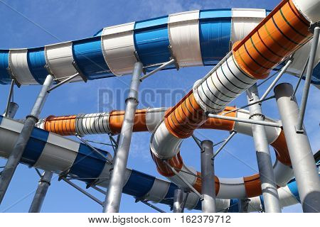 Slider in swimming pool and sky background