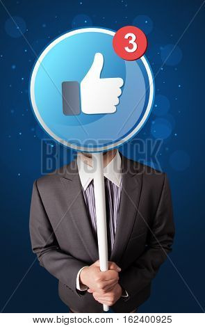 Smart businessman holding round sign with facebook like