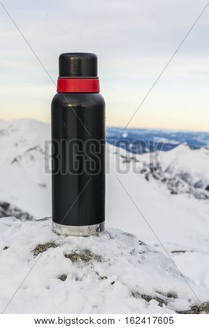 Black Thermos With Mountains In The Background.