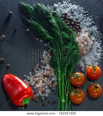 vegetables and spices on a black background
