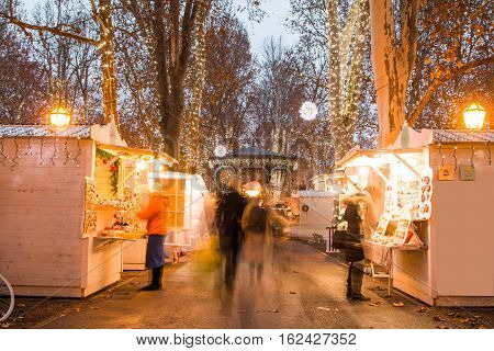 Advent time in the center of Zagreb, Croatia, people gathering in Zrinjevac park with food stands, blurred motion, unrecognizable people