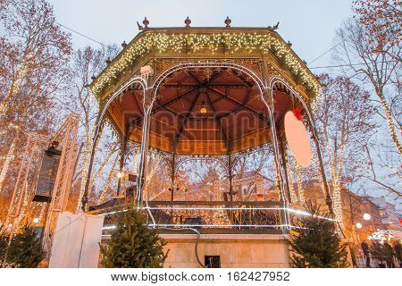 Advent time in the center of Zagreb, Croatia, music pavilion decorated with lights, unrecognizable people