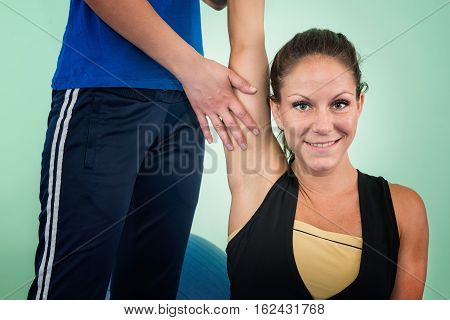 Physical therapy: working on shoulder flexion, toned image