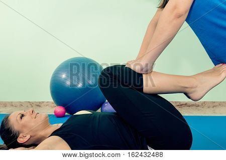 Physical therapist working with patient, toned image