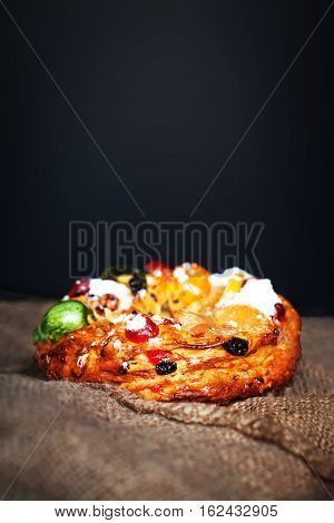 Merry Christmas cake with nuts - Bolo Rei is a traditional Xmas cake with fruits raisins nut and icing on wooden table with copy space
