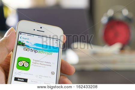 Bangkok, Thailand - December 14, 2016: Business man is using tripadvisor application to plan his trip.