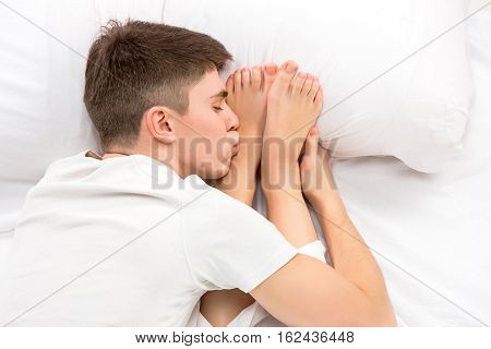 The young lovely couple lying in a white bed, love lconcept, top view