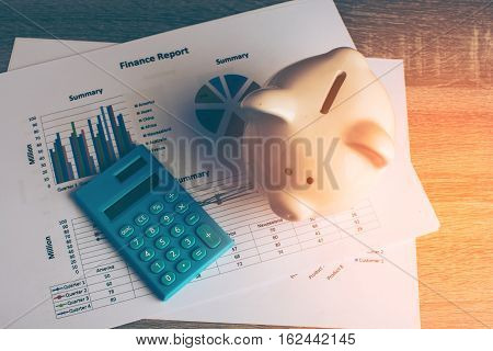 Piggy bank with business stuff, business and finance concept, vintage color tone.