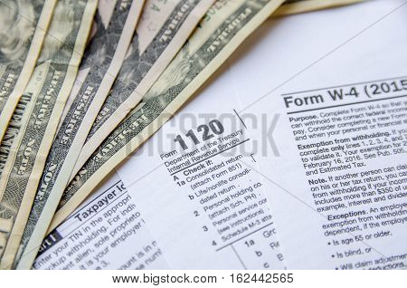 Tax Form W4 1120 1040 with dollar