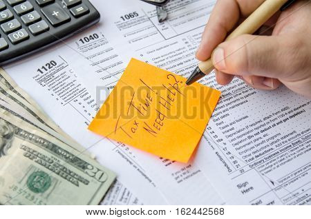 Tax form 1040 1120 1065 with pen calculator and sticker