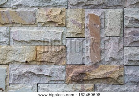 Stone wall from small pieces in gray color