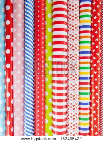 Cheerful background made from rolls of colorful wrapping paper