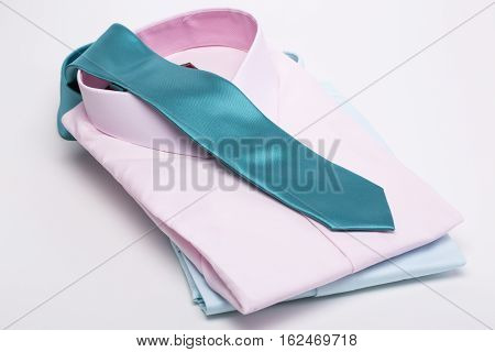 Pink shirt and turquoise shirt, turquoise tie on a white background