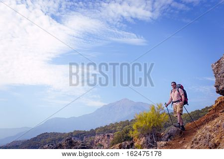 Summer hiking in the mountains with a backpack .